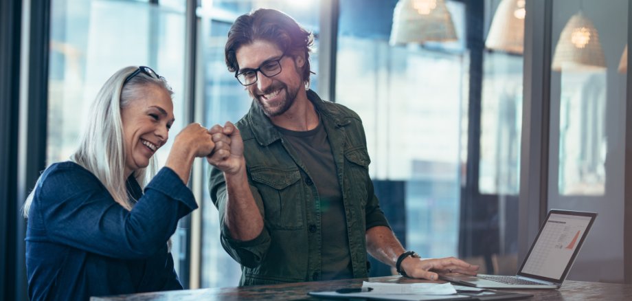 Business colleagues making a fist bump at office