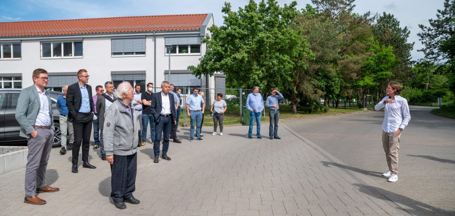 Das Foto zeigt den Rundgang der Teilnehmenden des ETA-Plus Netzwerktreffens über das ZAKB-Gelände. Christopher Göttelmann erklärt den Teilnehmenden etwas.