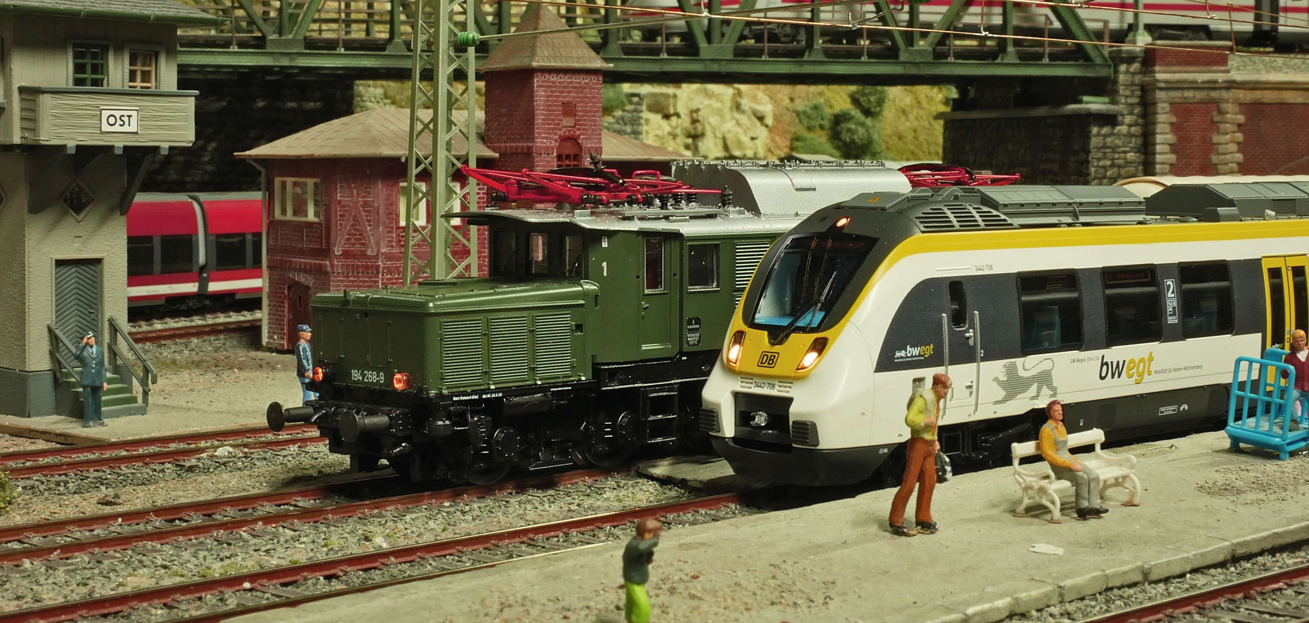 Ein paar Miniaturzüge stehen auf kleinen Gleisen.