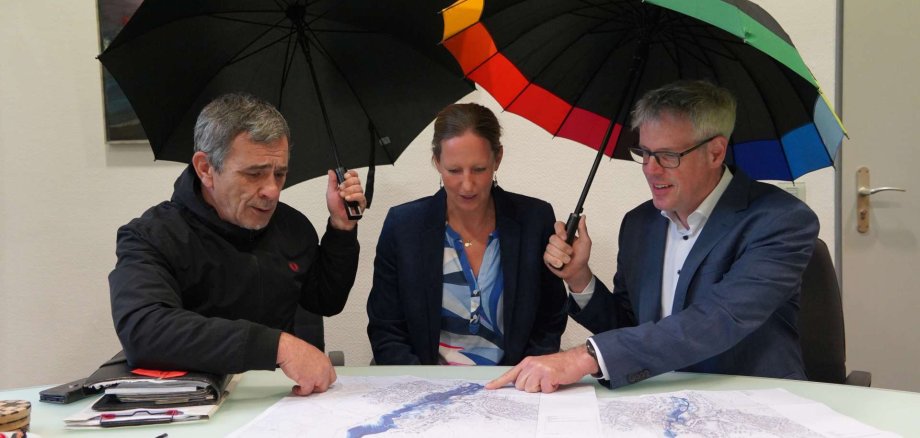 Landrat Christian Engelhardt (rechts) und Ulrich Androsch, Geschäftsführer des Gewässerverbands Bergstraße (links) besprechen mit Projektleiterin Katharina Wilkin (Mitte) die Installationsorte für die Sensoren des neuen Starkregen-Frühwarnsystems.