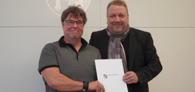 Der hauptamtliche Kreisbeigeordnete und für die Untere Naturschutzbehörde zuständige Dezernent Matthias Schimpf überreicht den Förderbescheid an den Vorsitzenden der Vogelschutzgruppe Lautertal Höhengemeinden e.V., Ingo Jahn.