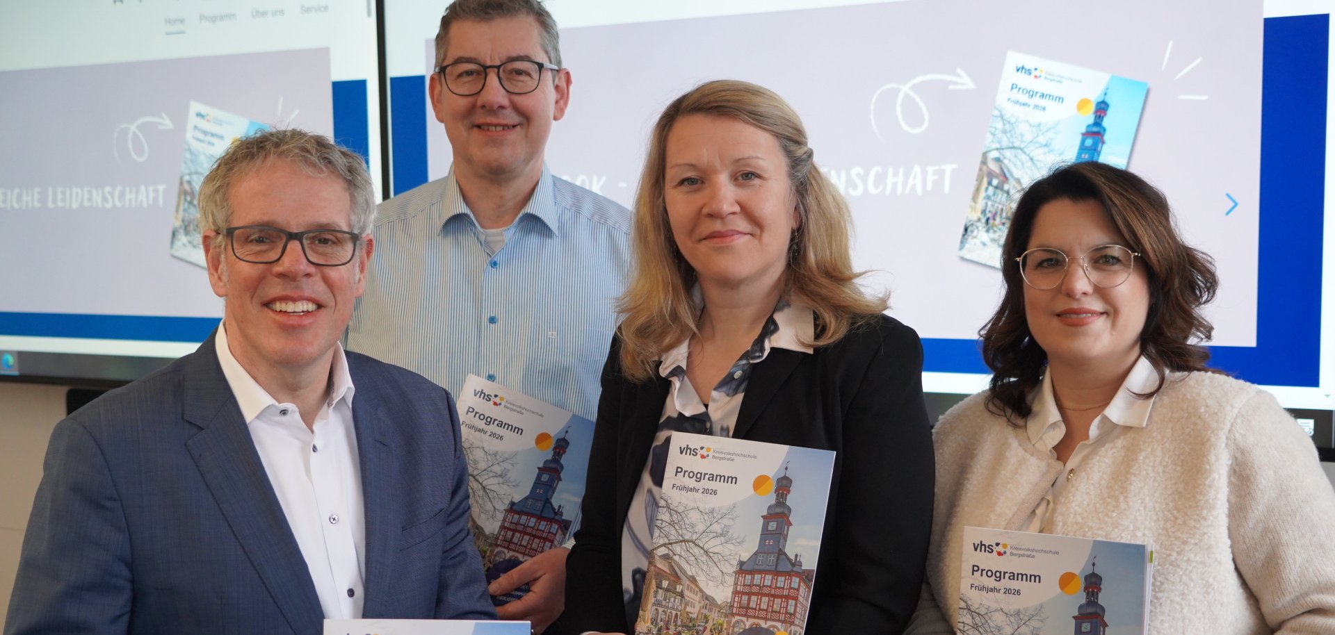 Landrat Christian Engelhardt, der stellvertretende KVHS-Leiter Ernst Heiligenthal, die KVHS-Leiterin Iwona Cissarz sowie die Fachbereichsleiterin Melanie Knauf stehen nebeneinander und halten das neue Frühjahrsprogramm der KVHS in den Händen.