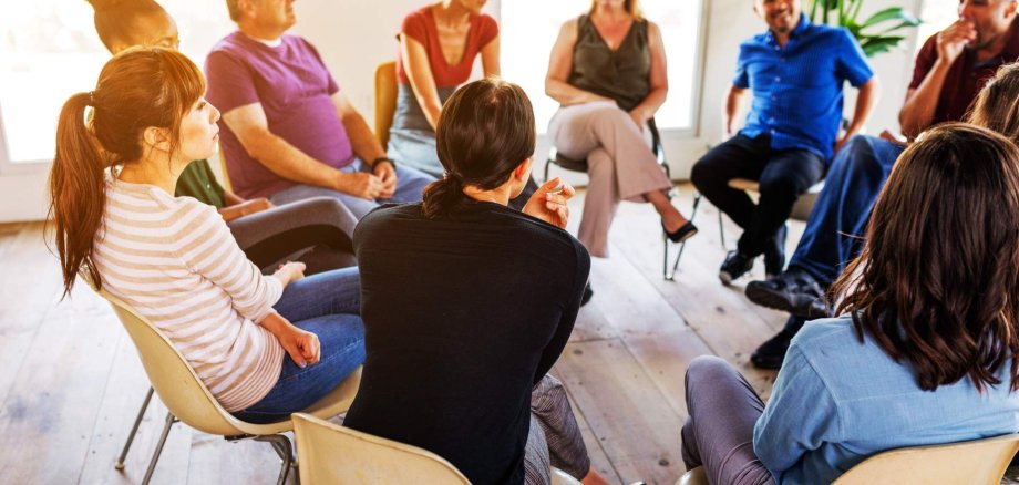 Support group meeting with diverse people in a circle Support group meeting with diverse people in a circle