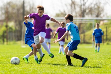 Kids soccer football - children players match on soccer field