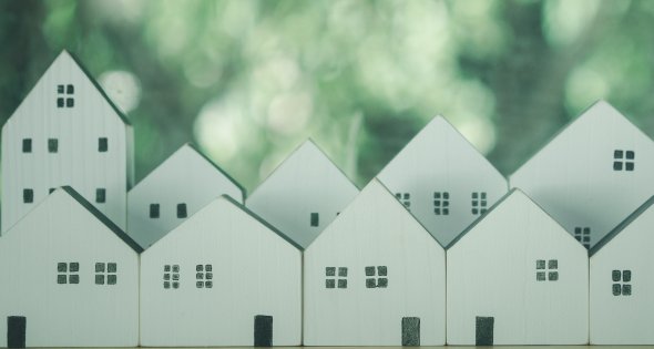 kleine Holzhäuser Modelle vor einem Naturhintergrund