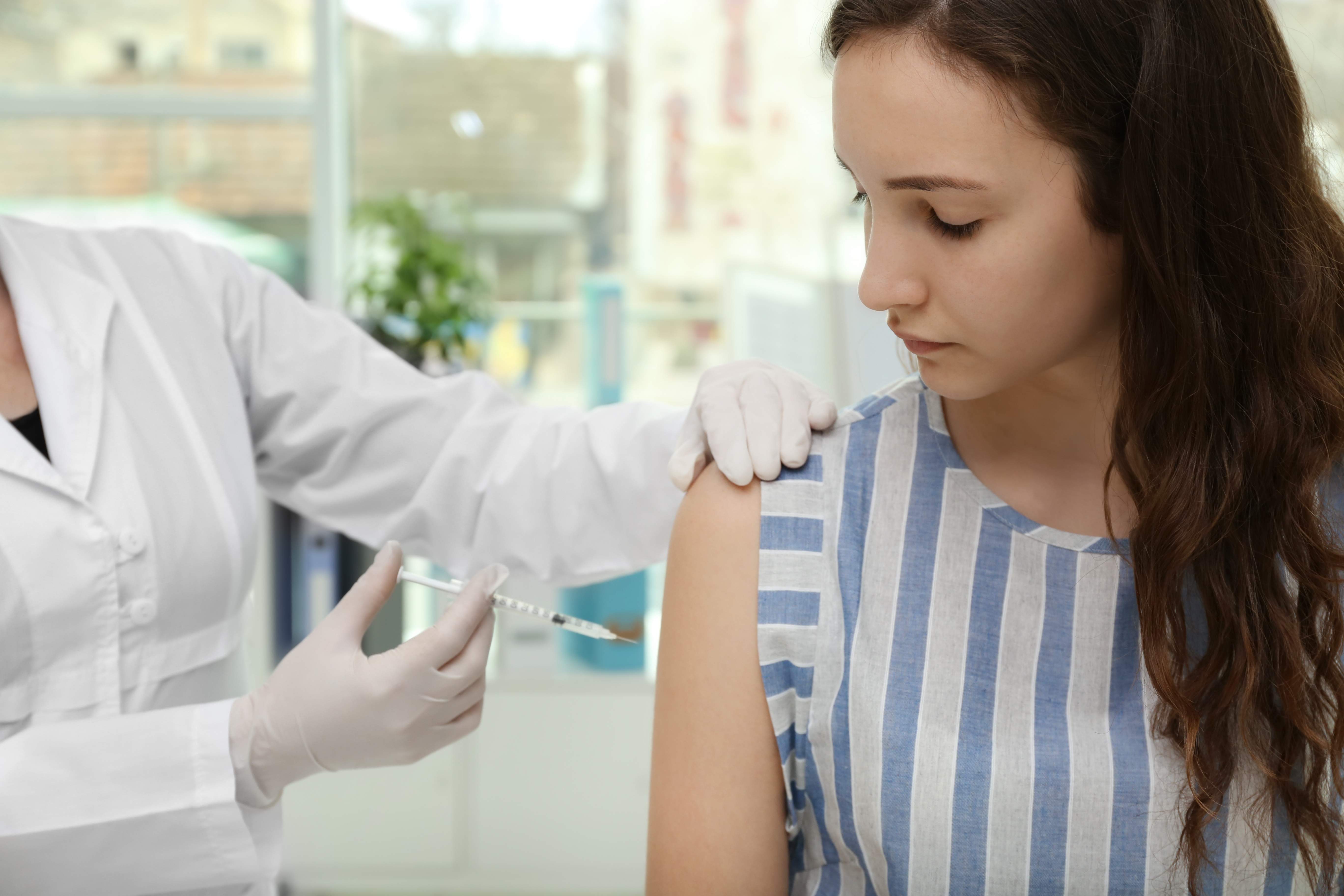 Young girl receiving vaccination in hospital