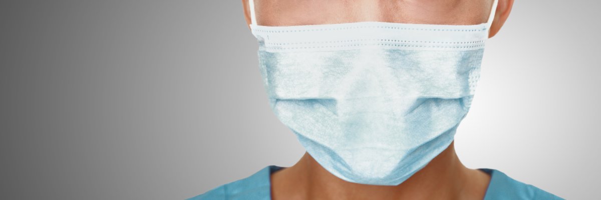Coronavirus surgical mask doctor wearing face protective mask against corona virus banner panoramic medical professional preventive gear.