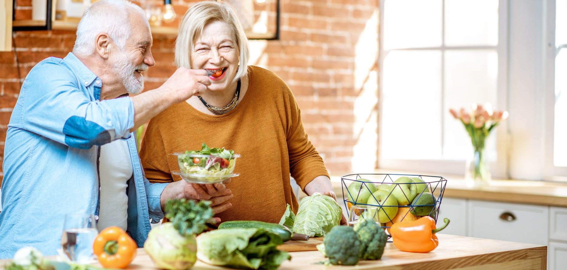 Senior couple with healthy food at home