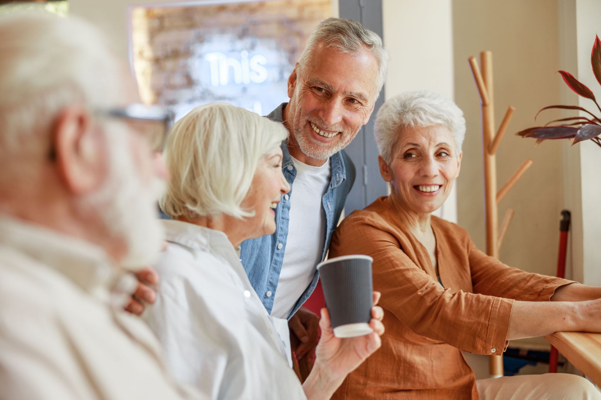 Joyful old friends spending time together in cafe