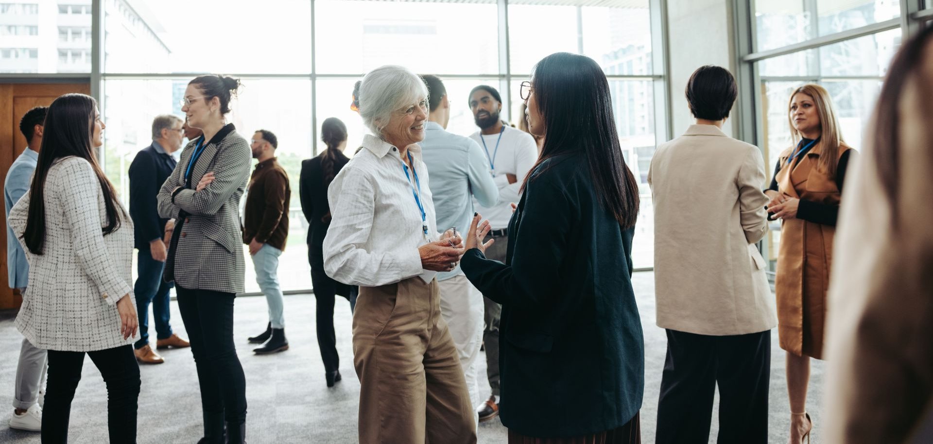 Diverse professionals networking at a business event in a modern office building
