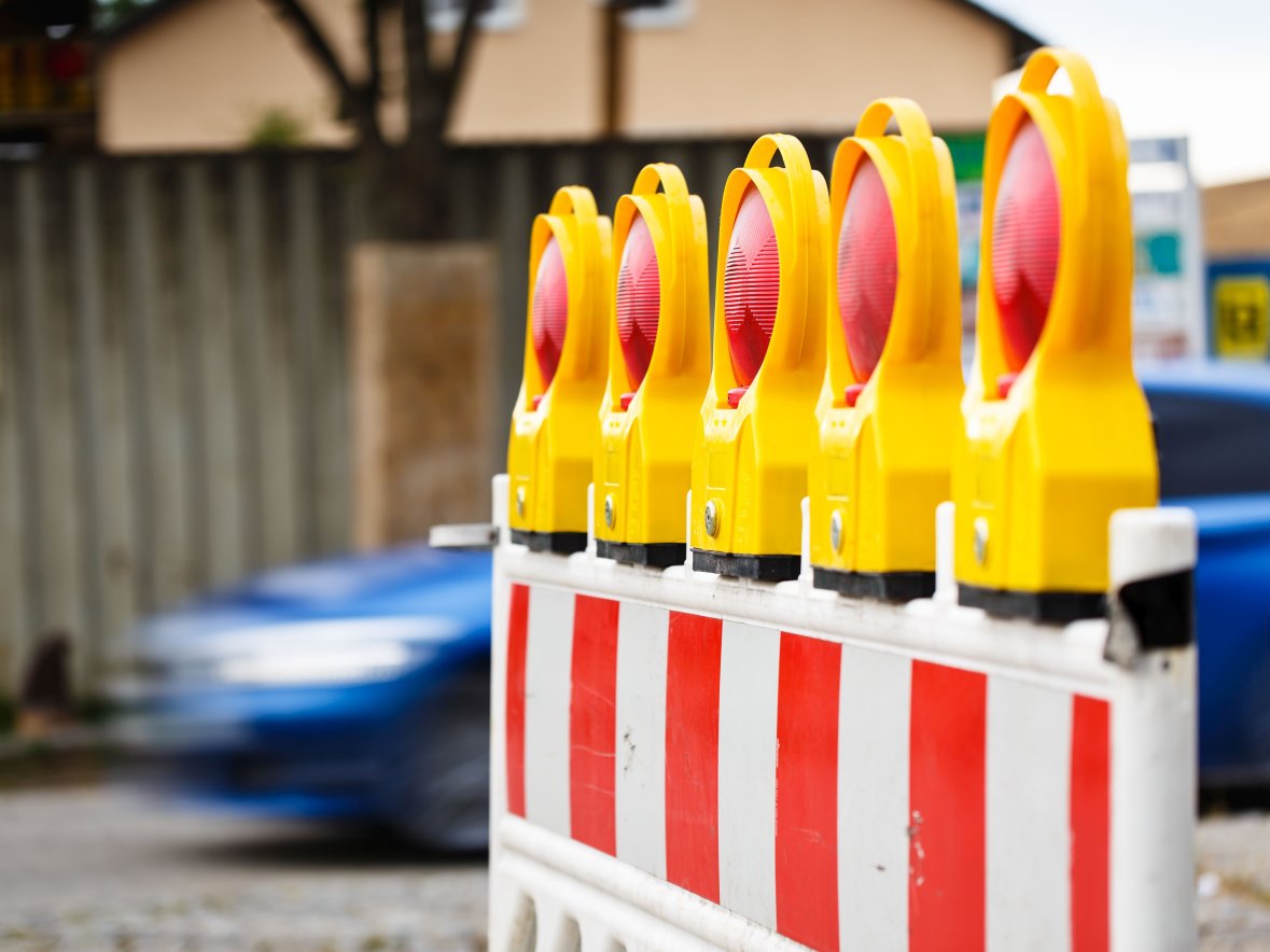 Straßenabsperrung Absperrung mit Warnlichter wegen Straßenschäden.