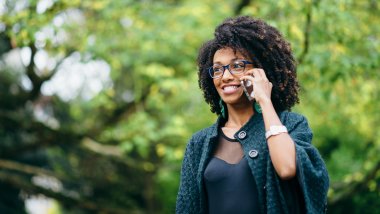 Happy black woman during a mobile phone call in autumn Happy black woman during a mobile phone call in autumn