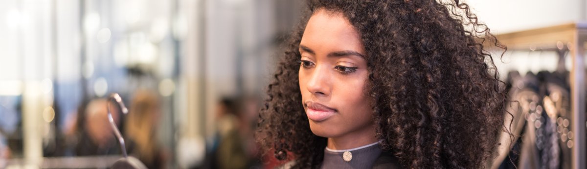 Black young woman doing shopping in a store