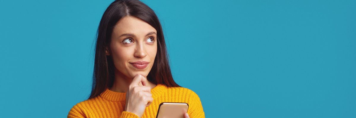 Girl thinks about mobile online offer, looks away contemplates about something