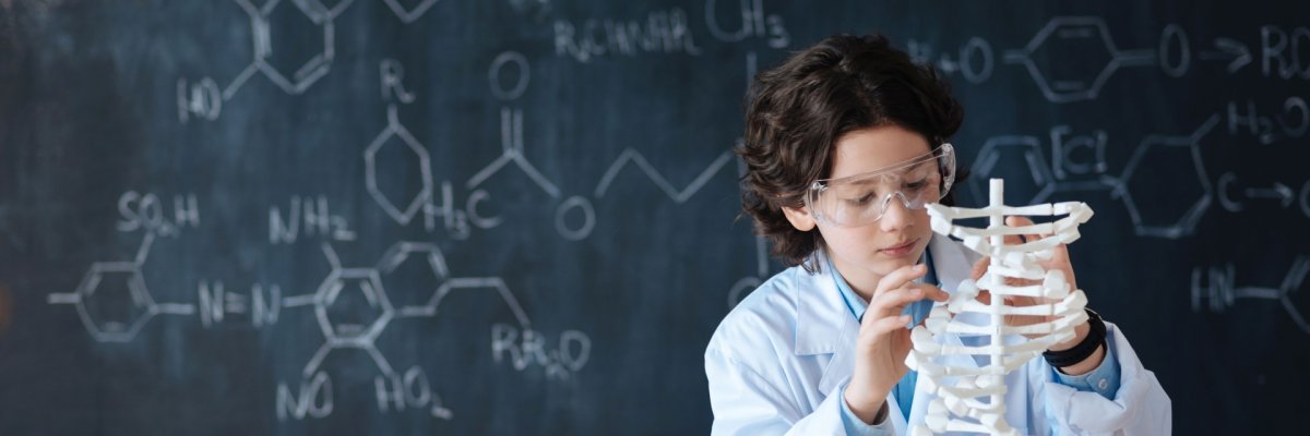 Smart pupil enjoying chemistry class at school