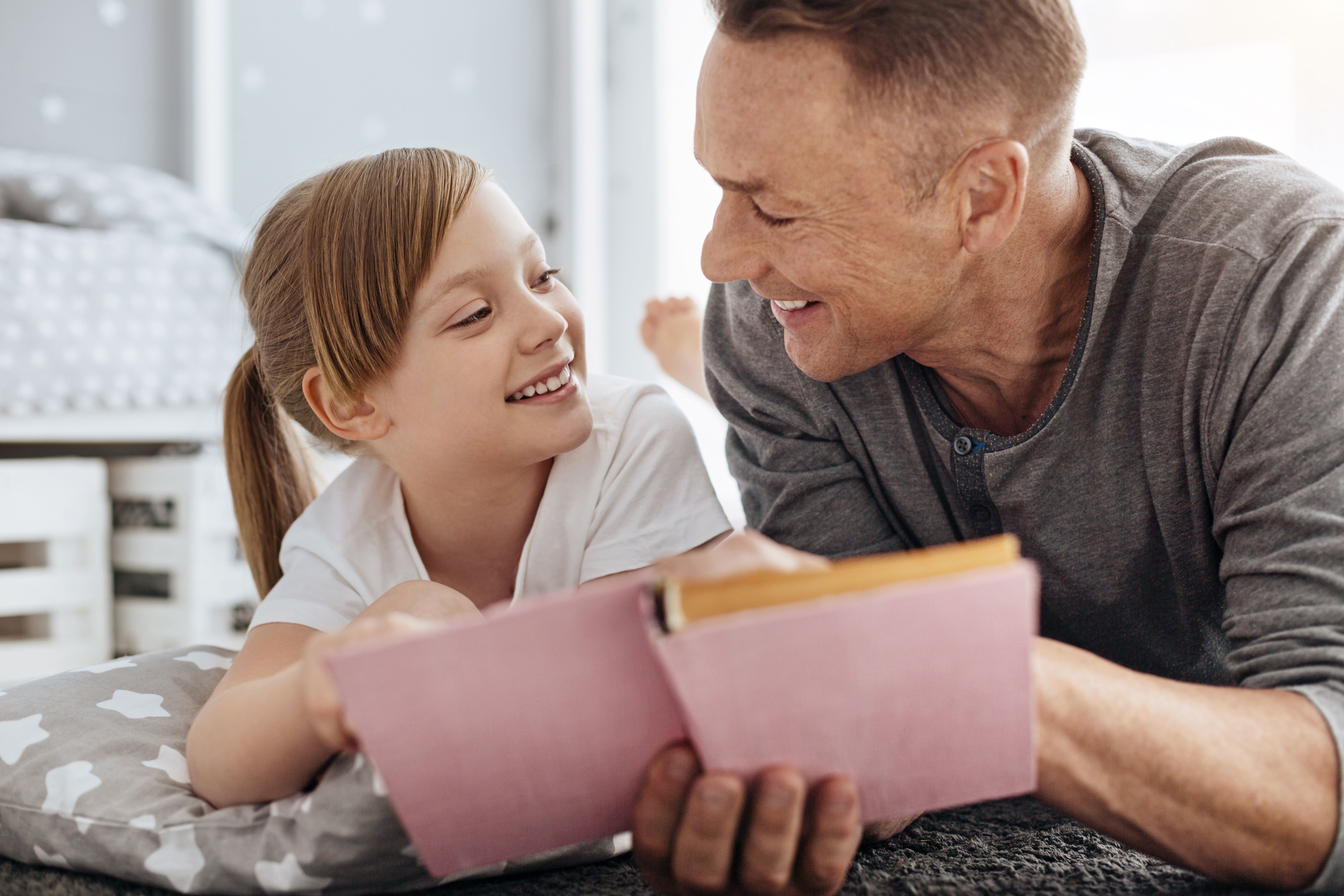 Lively girl and her dad sharing the same hobby