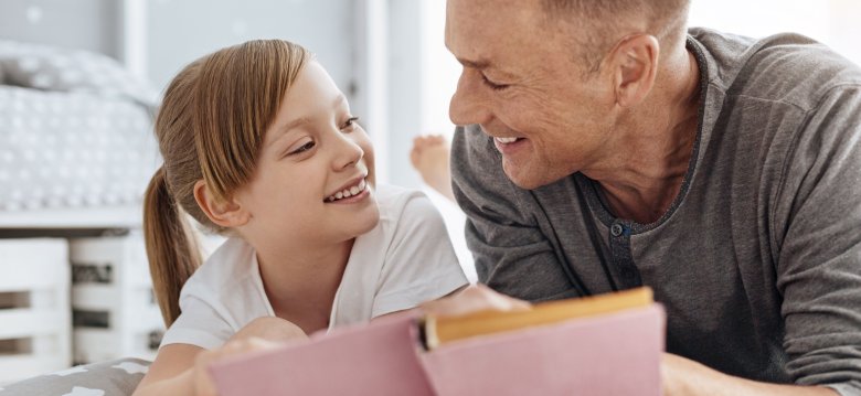 Lively girl and her dad sharing the same hobby